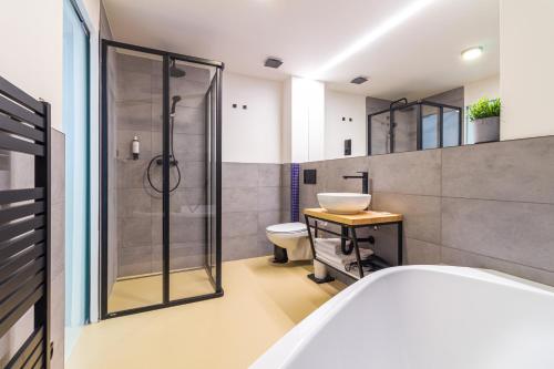 a bathroom with a shower and a toilet and a sink at Coffein apartments in Mostkovice