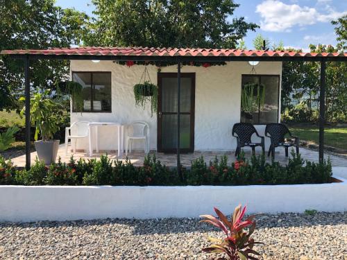 a cottage with a table and chairs on a patio at Cabañas Campestres en Villavicencio in Villavicencio