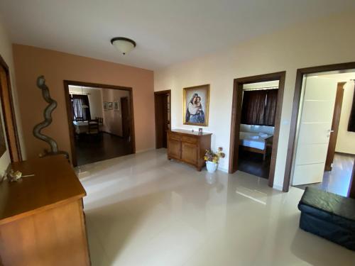 a large living room with white tile flooring and wooden furniture at Apartments Villa Lora in Kraj