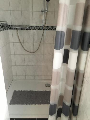 a shower with a black and white shower curtain at Haus Ursula 2 in Brake