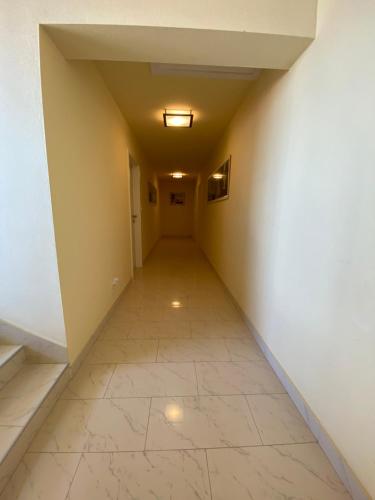 an empty hallway with a tile floor and a ceiling at Apartments Villa Lora in Kraj