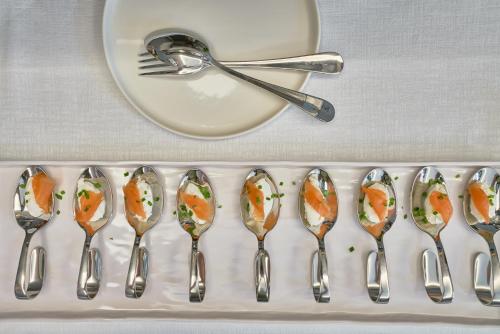 a tray with spoons and a plate and a fork at The Rif - Boutique Hotel in Pisa