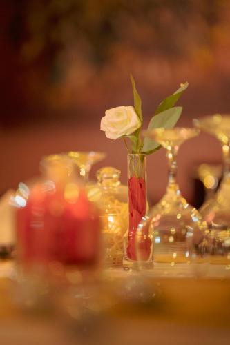 a vase with a rose in it on a table at Dar Ba Sidi & Spa in Chefchaouen