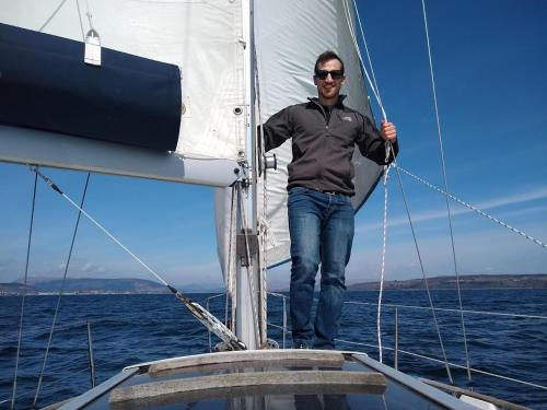 a man standing on the bow of a sail boat at Douglas Park Guest House in Dunoon