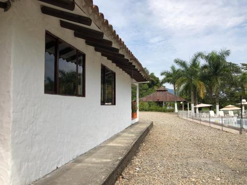 a white building with windows on the side of it at Cabañas Campestres en Villavicencio in Villavicencio