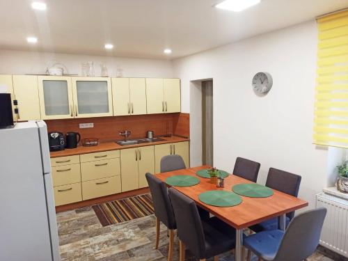 a kitchen with a table and chairs in a room at Ubytování 121 - Hlohovec in Hlohovec