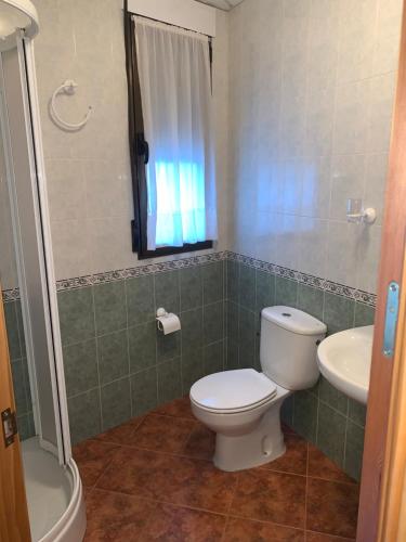 a bathroom with a toilet and a sink at Apartamento El Campanario in Zuheros