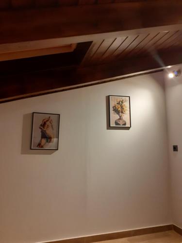three pictures on the wall of a room at The view attic in Ioannina