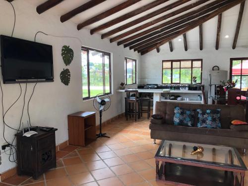 a living room with a couch and a flat screen tv at Cabañas Campestres en Villavicencio in Villavicencio