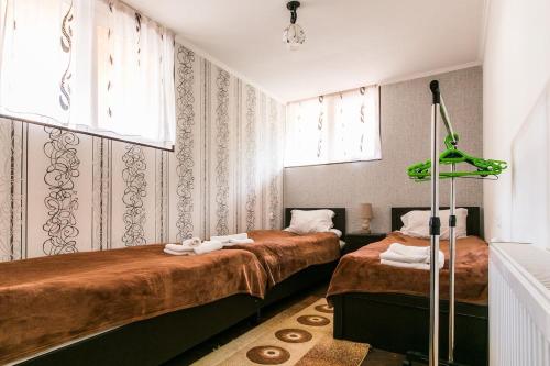 a bedroom with two beds and a window at Georgian Guest House on Asatiani in Tbilisi City