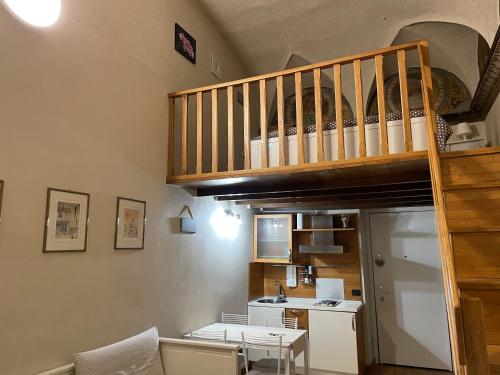 a living room with a staircase and a kitchen at Bramantesco in Bergamo