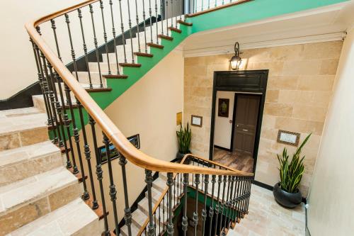 a staircase in a home with a green and white stair railing at Hôtel de Charme Le Provence in Salon-de-Provence