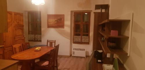 a kitchen with a wooden table and a dining room at Apartmán náměstí 2 in Horní Blatná