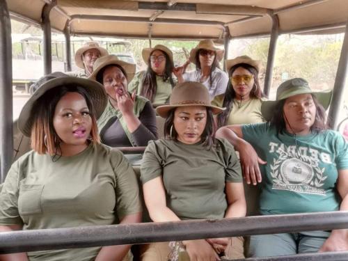 a group of people wearing hats sitting in a bus at Asante’s Guest House in Calcutta