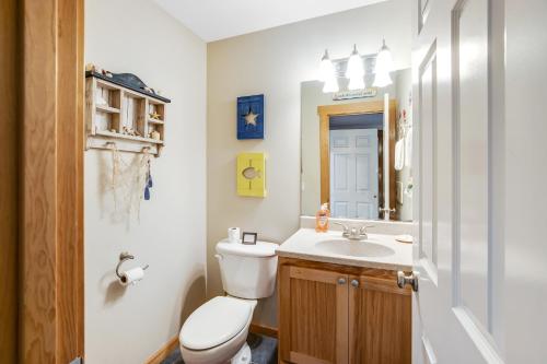 a bathroom with a toilet and a sink and a mirror at The Hidden Treasure in Warrenton