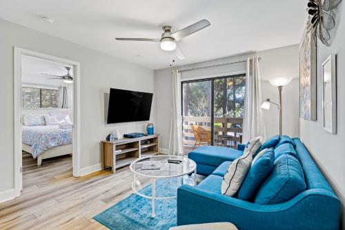 a living room with a blue couch and a tv at Fiddlers Cove 19E in Hilton Head Island