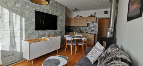 米托彭督比耶羅的住宿－Apartmán Chopok，厨房以及带沙发和桌子的客厅。