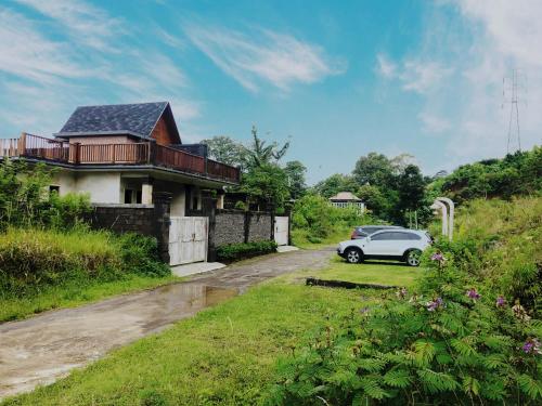 a car parked in front of a house at BUYAN LODGE lake view villa in Bedugul