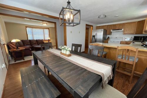 a kitchen and living room with a wooden table and a dining room at Spacious, Sunny Lake House! Close to ski trails. in Windsor