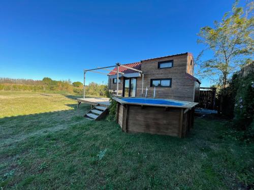 a small house with a swimming pool and a deck at myinsolite - Tiny-house, jacuzzi, brasero, piscine in Aigues-Mortes