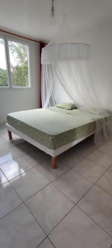a bedroom with a bed in a room with a window at Edelweis in Sainte-Luce