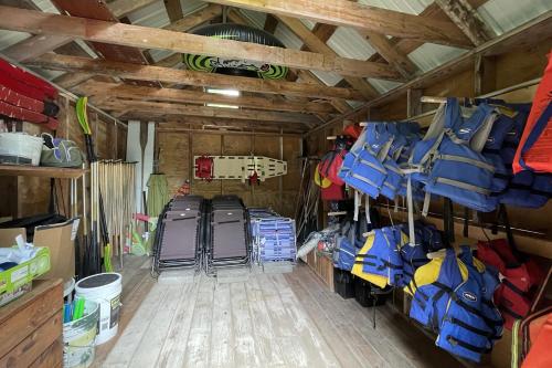 a room with a bunch of luggage in a barn at Spacious, Sunny Lake House! Close to ski trails. in Windsor