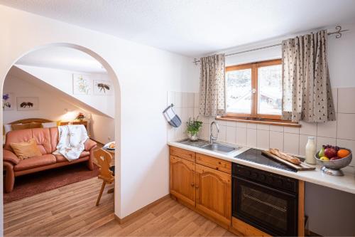 a kitchen with an archway leading to a living room at Schittlerhof in Fischen