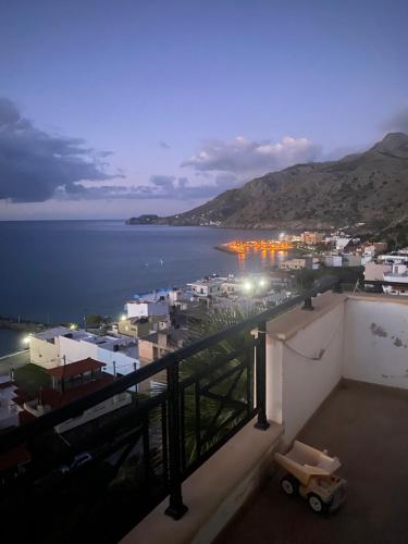 a view of a city and the ocean at night at Minoan house in Tsoutsouros