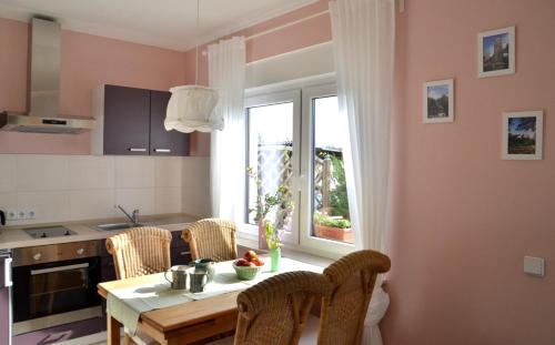a kitchen with a table and chairs and a window at Pension Horn Bautzen in Bautzen