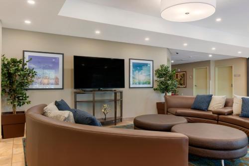 a living room with couches and a flat screen tv at Candlewood Suites Reading by IHG in Reading