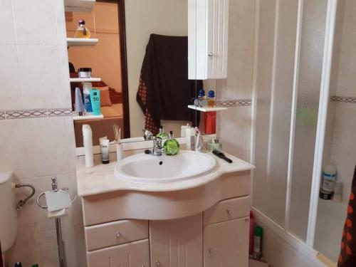 a bathroom with a sink and a mirror at Altura Beach House in Altura