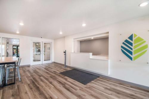 a living room with a table and a tv at WoodSpring Suites Portland Vancouver in Vancouver