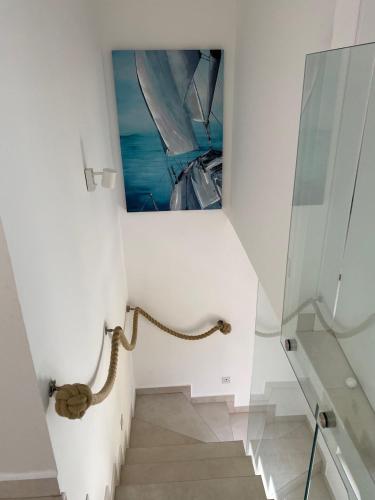 a staircase with a picture of a boat on the wall at Amazing villa Galeb in Murter in Murter