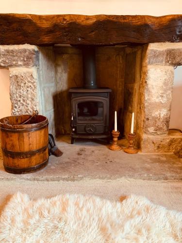 a fireplace with a stove and two candles in a room at Busfeild Arms in Keighley
