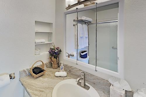 a bathroom with a sink and a glass shower at Casa Azul in Western Sedona in Sedona
