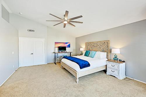 a bedroom with a bed and a ceiling fan at Serenity Now in Phoenix