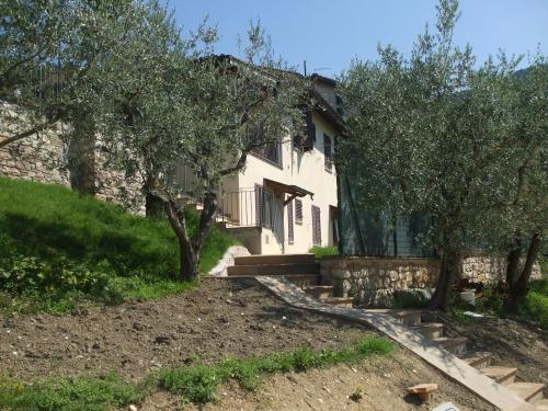 a house with trees in front of it at Camere Ramaccia in Assisi