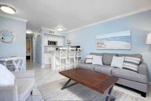 a living room with a couch and a table at Victorian Condo #9227 in Galveston