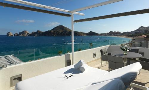 a balcony with a bed and a view of the ocean at ME Cabo by Meliá in Cabo San Lucas