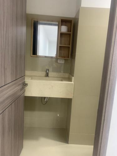 a bathroom with a sink and a mirror at Hotel Wanderlust in Santa Marta