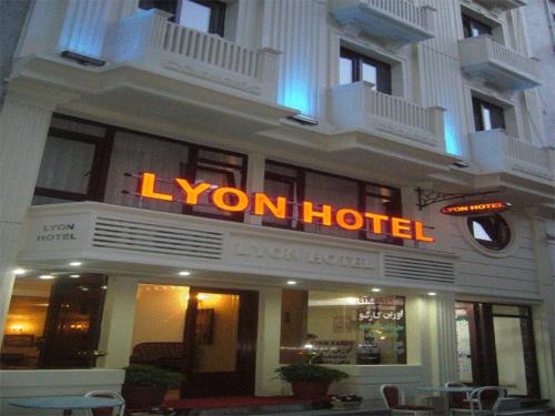 a hotel with a neon sign on the front of it at Lyon Hotel İstanbul in Istanbul