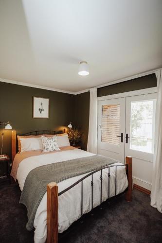 a bedroom with a large bed and a window at Mountford Cottage in Metung