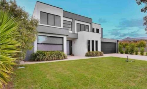 a large white house with a green yard at Bundalong river retreat in Bundalong