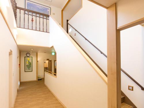 a hallway with a staircase in a house at Tateyama Kurobe Alpine Route Senjuso 立山黒部アルペンルート千寿荘 in Tateyama
