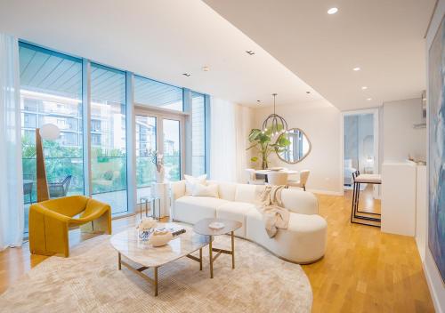 a living room with a white couch and a table at Nasma Luxury Stays - Blue Waters Island in Dubai