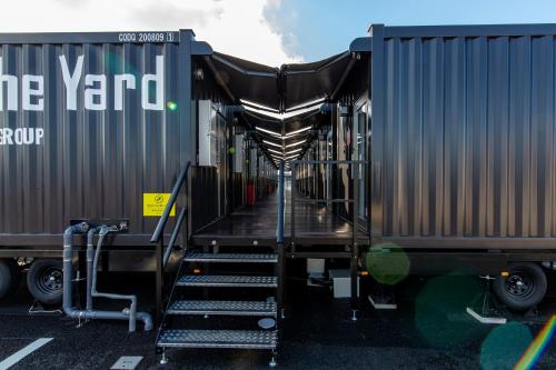 a train car with stairs leading to the end of it at HOTEL R9 The Yard Nakatsu in Nakatsu