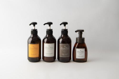 four bottles of wine against a white background at HOTEL R9 The Yard Nakatsu in Nakatsu