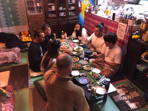 a group of people sitting around a table eating food at Happy Island Miyako in Miyako Island