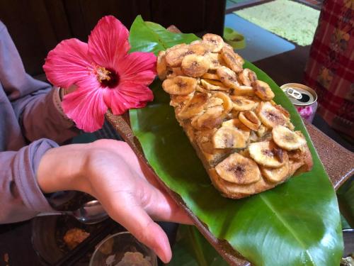 a person holding a plate of food with a flower at Happy Island Miyako in Miyako Island