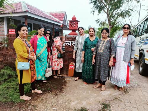 a group of women standing in front of a bus at Swaru Luxurious Villa in Tamhini Ghat & Kolad Rafting in Nizāmpur